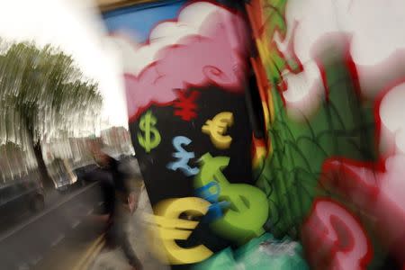 Painted monetary symbols are seen on a wall in Dublin city centre October 22, 2014. REUTERS/Cathal McNaughton