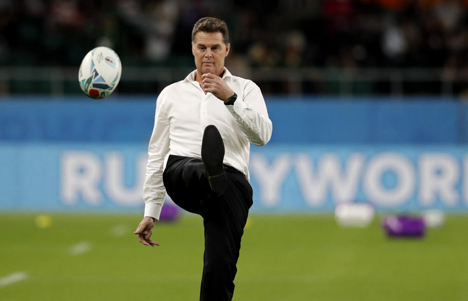 South Africa's coach Rassie Erasmus kicks a ball as he watches his team warm up ahead of the Rugby World Cup Pool B game at Shizuoka Stadium Ecopa between South Africa and Italy, in Shizuoka, Japan, Friday, Oct. 4, 2019. (AP Photo/Shuji Kajiyama)