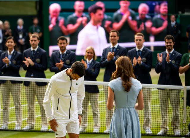 <p>TPN/Getty </p> Novak Djokovic bows to Kate Middleton at Wimbledon 2019