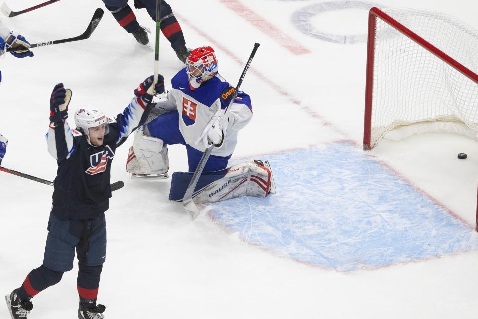 United States' John Farinacci (25) celebrates his goal on Slovakia goalie Simon Latkoczy (30) during the second period of an IIHL World Junior Hockey Championship game, Saturday, Jan. 2, 2021 in Edmonton, Alberta. (Jason Franson/The Canadian Press via AP)