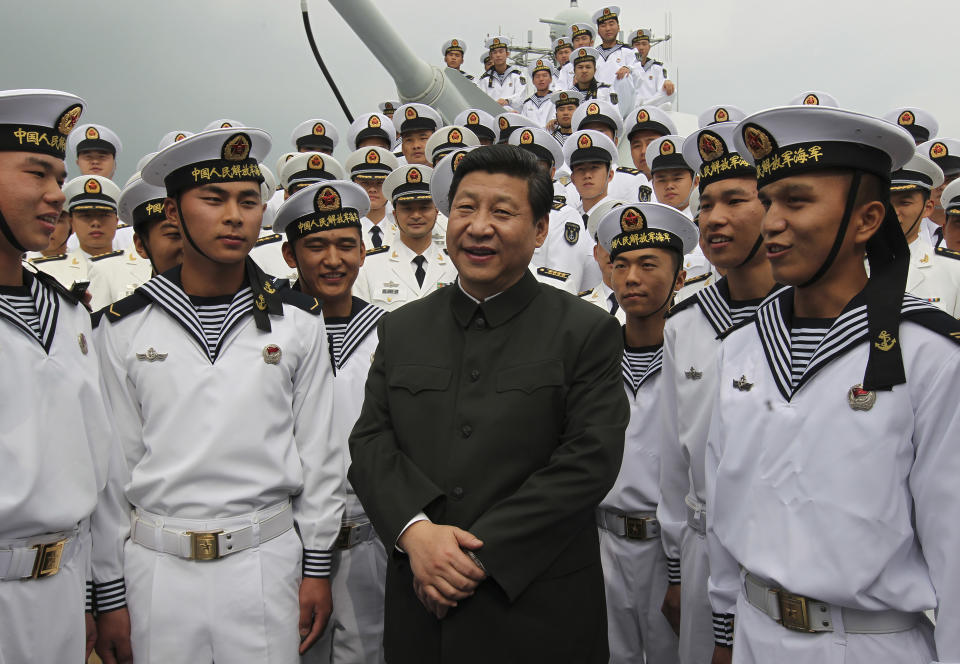 FILE - In this photo released by Xinhua News Agency, Xi Jinping, center, general secretary of the Communist Party of China talks to sailors onboard the Haikou navy destroyer during his inspection of the Guangzhou military theater of operations of the People's Liberation Army (PLA) in Guangzhou, China on Dec. 8, 2012. When Xi Jinping came to power in 2012, it wasn't clear what kind of leader he would be. His low-key persona during a steady rise through the ranks of the Communist Party gave no hint that he would evolve into one of modern China's most dominant leaders, or that he would put the economically and militarily ascendant country on a collision course with the U.S.-led international order. (Wang Jianmin/Xinhua via AP, File)