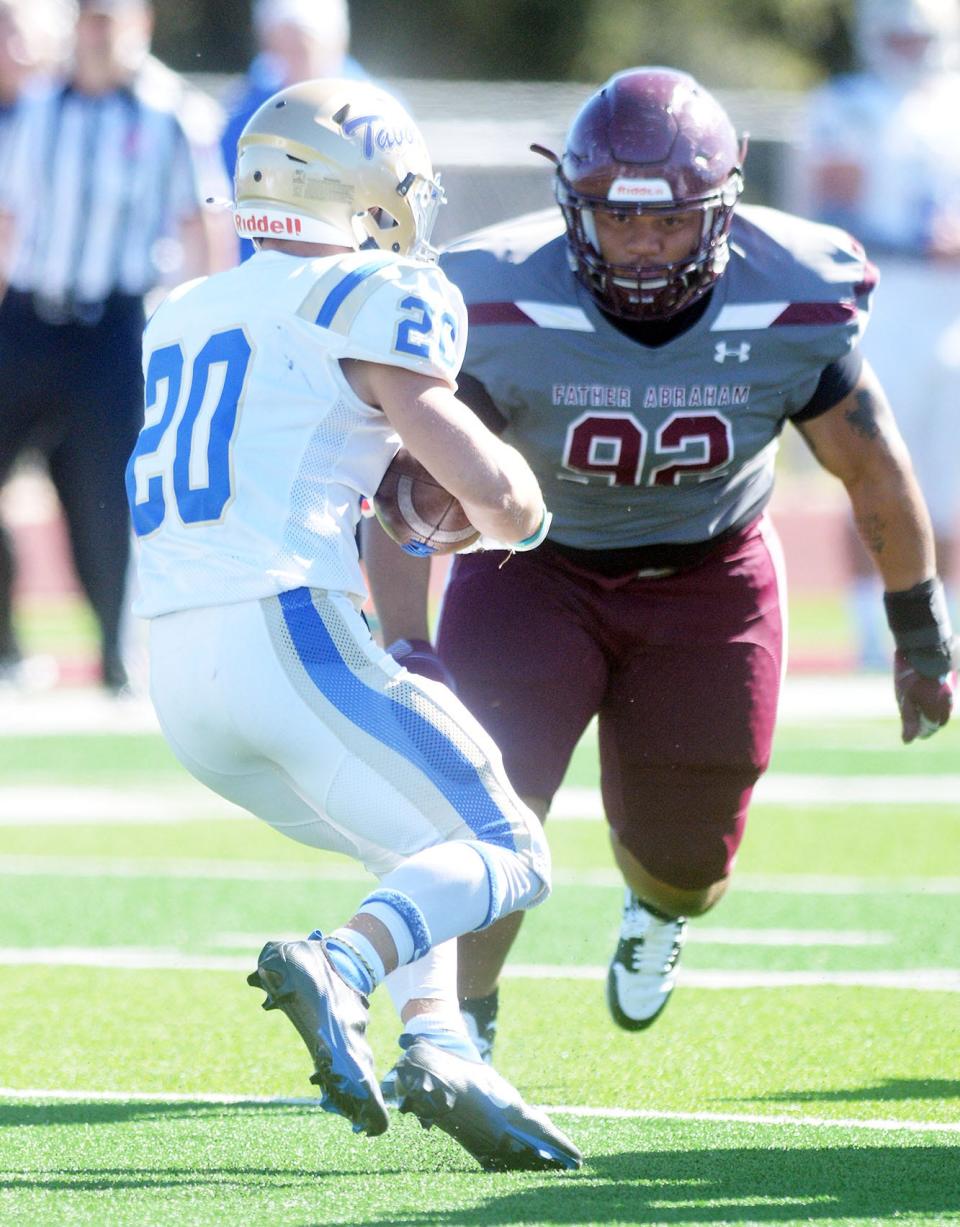 Bethel senior Mark Lanier goes after Tabor running back Jakob Fiel during play Saturday. Tabor was held to 11 yards rushing in a 49-21 Bethel win.