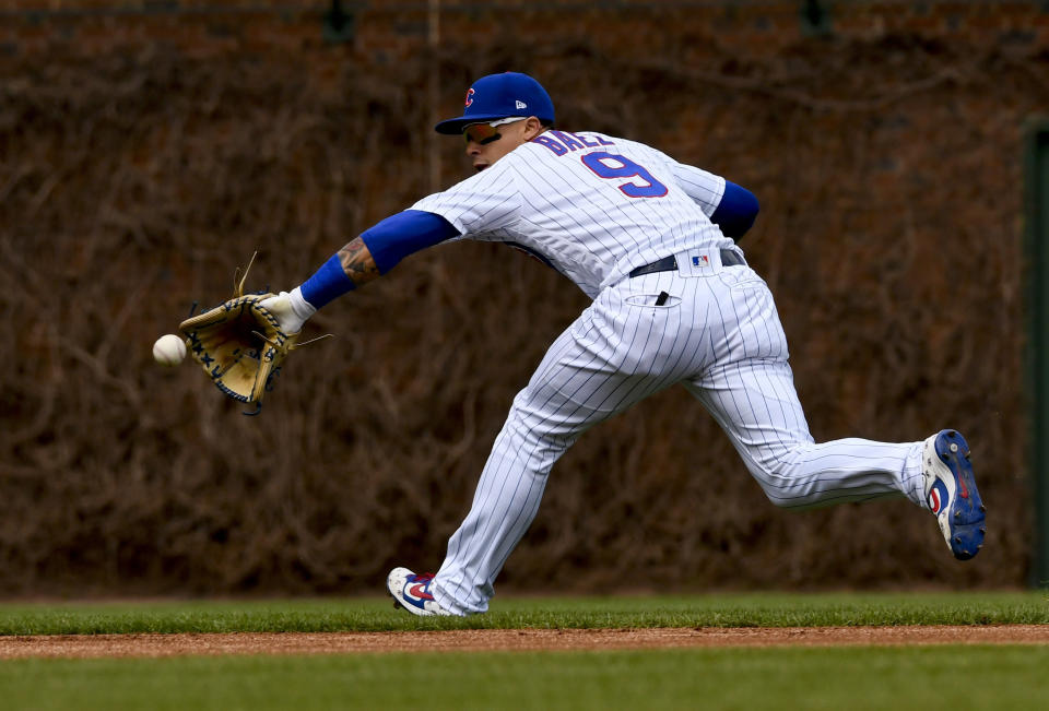 Chicago Cubs shortstop Javier Baez stops a ball hit by Los Angeles Angels' David Fletcher during the first inning of a baseball game Friday, April 12, 2019, in Chicago. (AP Photo/Matt Marton)