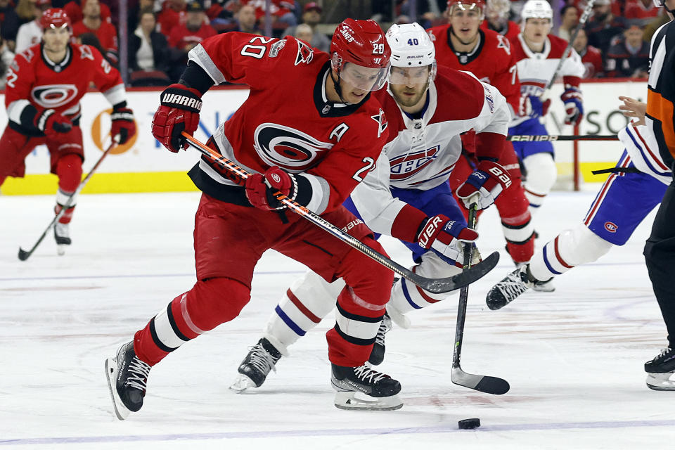 Carolina Hurricanes' Sebastian Aho (20) skates with the puck in front of Montreal Canadiens' Joel Armia (40) during the second period of an NHL hockey game in Raleigh, N.C., Thursday, Feb. 16, 2023. (AP Photo/Karl B DeBlaker)