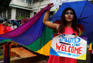 <p>A member of a group supporting LGBT rights displays a placard during a protest ahead of U.S. President Donald Trump’s visit, at the University of the Philippines in Los Banos, Laguna, Philippines, Nov. 9, 2017. (Photo: Erik De Castro/Reuters) </p>