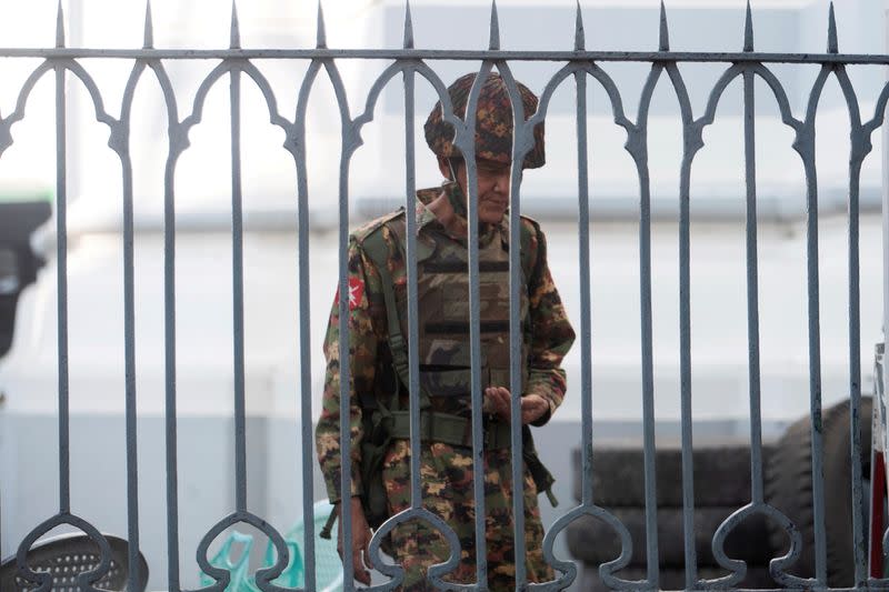 Myanmar soldiers look on as they stand inside Yangon City Hall after they occupied the building, in Yangon, Myanmar