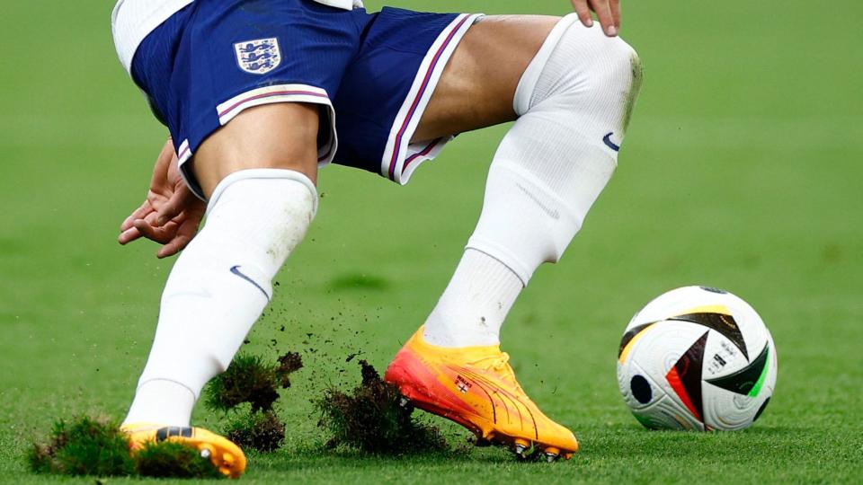 Grass cuts up as an England player turns for the ball