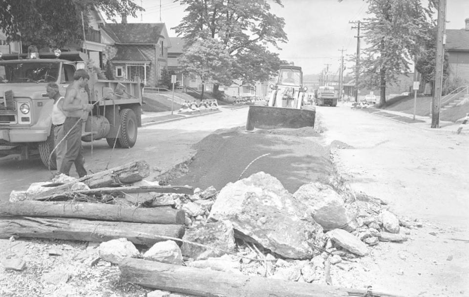 This photo shows old streetcar tracks being removed from the 900 block of South 13th Street, Manitowoc, on June 17, 1971.