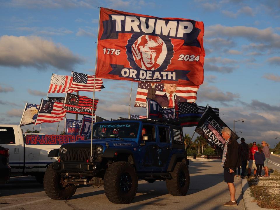 Robert Fix shows his support for Donald Trump by flying a "Trump or death" flag near the embattled former president's Mar-a-Lago home on March 20, 2023 in Palm Beach, Florida.