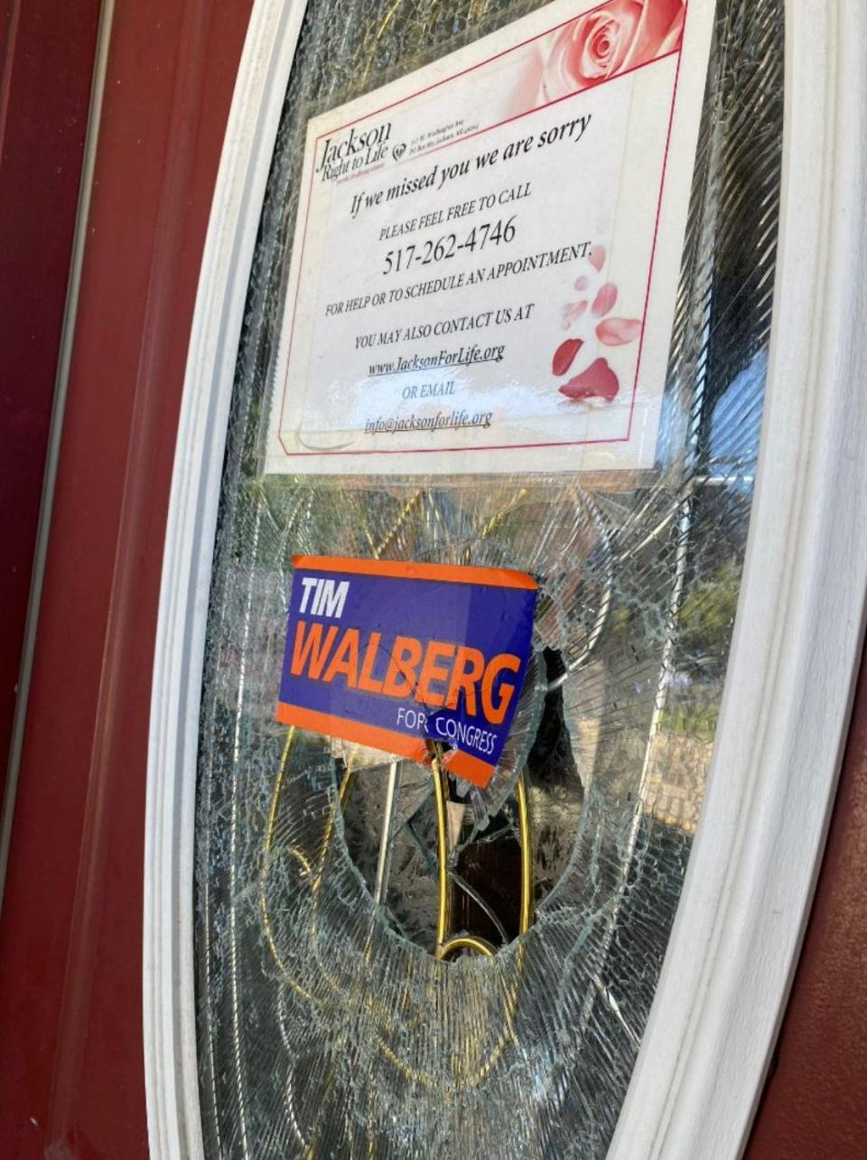 A smashed window in the door to an office in Jackson shared by Jackson Right to Life and U.S. Rep. Tim Walberg's reelection campaign is pictured.