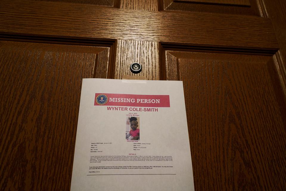 Signs are seen posted on doors in the building outside of an apartment where Rashad Trice, 26, is accused of kidnapping Wynter Cole Smith, 2, on Sunday night after stabbing and assaulting her mother at their home in the 3000 block of BeauJardin Drive in the Towne Square Apartments and Townhomes in Lansing.