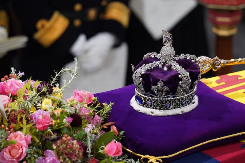 The coffin of Queen Elizabeth II, draped in the Royal Standard with the Imperial State Crown and the Sovereign’s Sceptre.