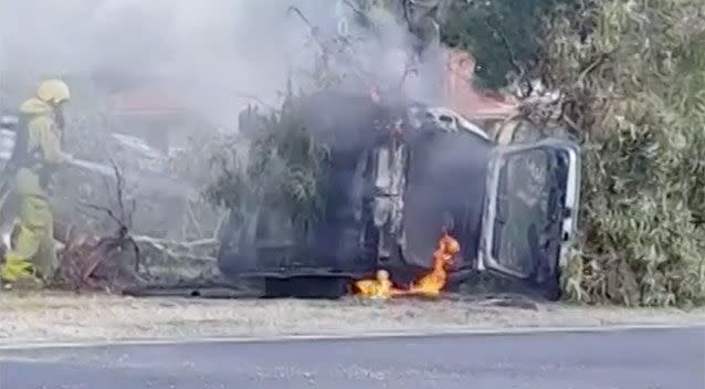 A fire fighter douses the flames. Source: 7 News