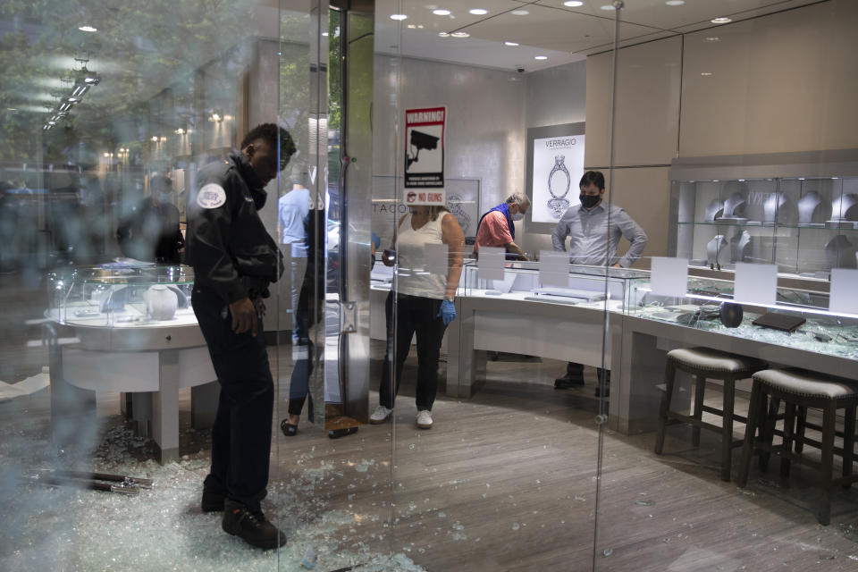 Shattered window and door glass is scattered on the floor inside Mervis Diamond Importers in Washington, Monday, June 1, 2020, after a night of protests over the death of George Floyd. Floyd died after being restrained by Minneapolis police officers. (AP Photo/Carolyn Kaster)