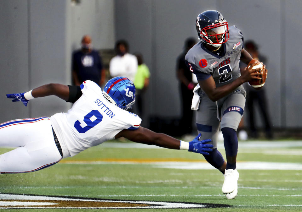 Jackson State quarterback Shedeur Sanders (2) breaks a tackle by Tennessee State defensive lineman Nate Sutton (9) during the Southern Heritage Classic NCAA college football game in Memphis, Tenn., Saturday, Sept. 11, 2021. (Patrick Lantrip/Daily Memphian via AP)