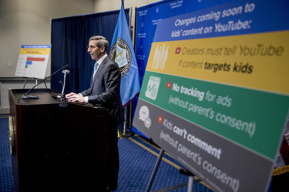 A sign with coming changes to kids' comment on YouTube is displayed as Federal Trade Commission Chairman Joe Simons speaks at a news conference at the Federal Trade Commission in Washington, Wednesday, Sept. 4, 2019, to announce that Google's video site YouTube has been fined $170 million to settle allegations it collected children's personal data without their parents' consent. (AP Photo/Andrew Harnik)