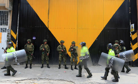 Colombian police and soldiers guard a supermarket supposedly linked to FARC in Bogota, Colombia February 21, 2018. REUTERS/Jaime Saldarriaga