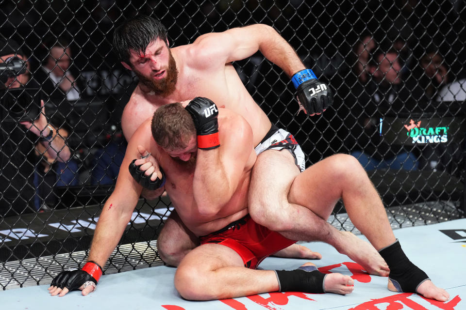 LAS VEGAS, NEVADA - DECEMBER 10: (R-L) Magomed Ankalaev of Russia controls the body of \jb1 in their UFC light heavyweight championship fight during the UFC 282 event at T-Mobile Arena on December 10, 2022 in Las Vegas, Nevada. (Photo by Chris Unger/Zuffa LLC)