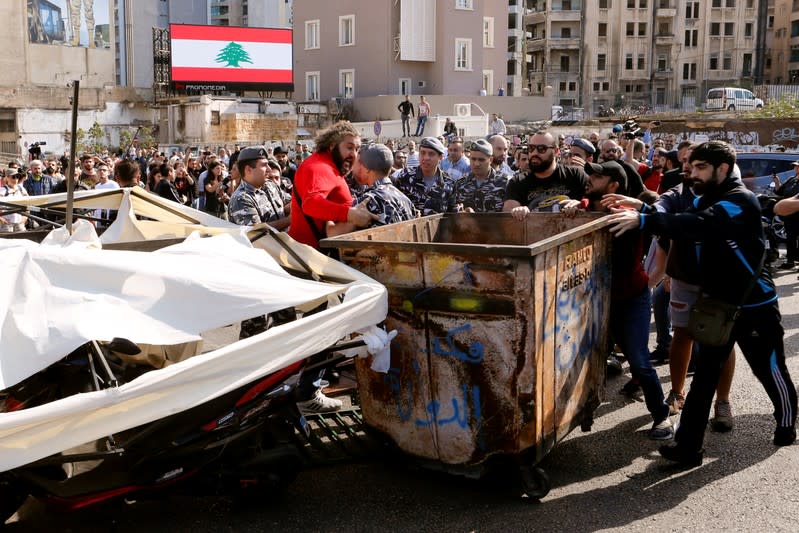 Police intervene after supporters of the Lebanese Shi'ite groups Hezbollah and Amal fought with protesters at a roadblock on a main road in Beirut