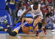 Golden State Warriors guard Stephen Curry, below, tries to pass the ball from the floor under pressure from Los Angeles Clippers guard Darren Collison during the second half in Game 1 of an opening-round NBA basketball playoff series, Saturday, April 19, 2014, in Los Angeles. The Warriors won 109-105. (AP Photo/Mark J. Terrill)