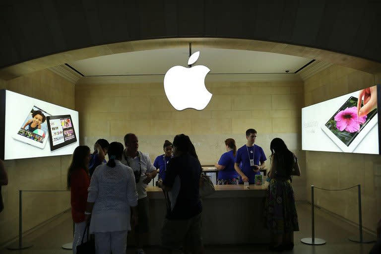 People are seen at Apple store in Grand Central Terminal in New York, on July 31, 2012. Apple reported its quarterly profit dipped for the first time in nearly a decade as it squeezed less money from its champions in the competitive smartphone and tablet markets