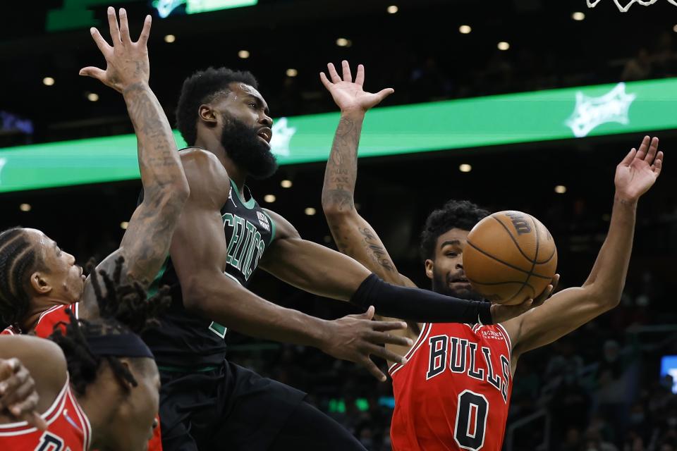 Boston Celtics' Jaylen Brown (7) shoots against Chicago Bulls' Coby White (0) during the second half of an NBA basketball game, Saturday, Jan. 15, 2022, in Boston. (AP Photo/Michael Dwyer)