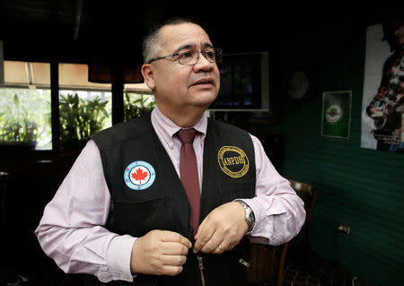 Nicaraguan human rights activist Alvaro Leiva adjusts his vest before speaking with Reuters after the Costa Rican government granted him political asylum, in San Jose, Costa Rica October 11, 2018. REUTERS/Juan Carlos Ulate