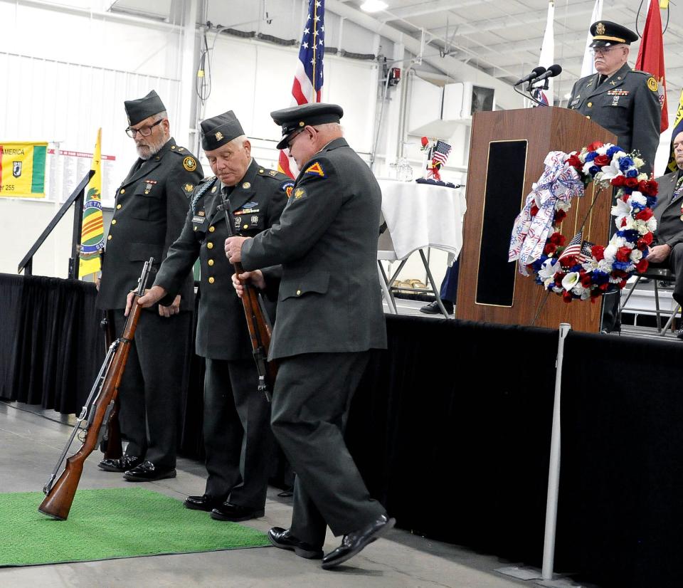 Members of the Triple Nickel reenact the stacking of rifles during the Wayne County Veterans Day program.