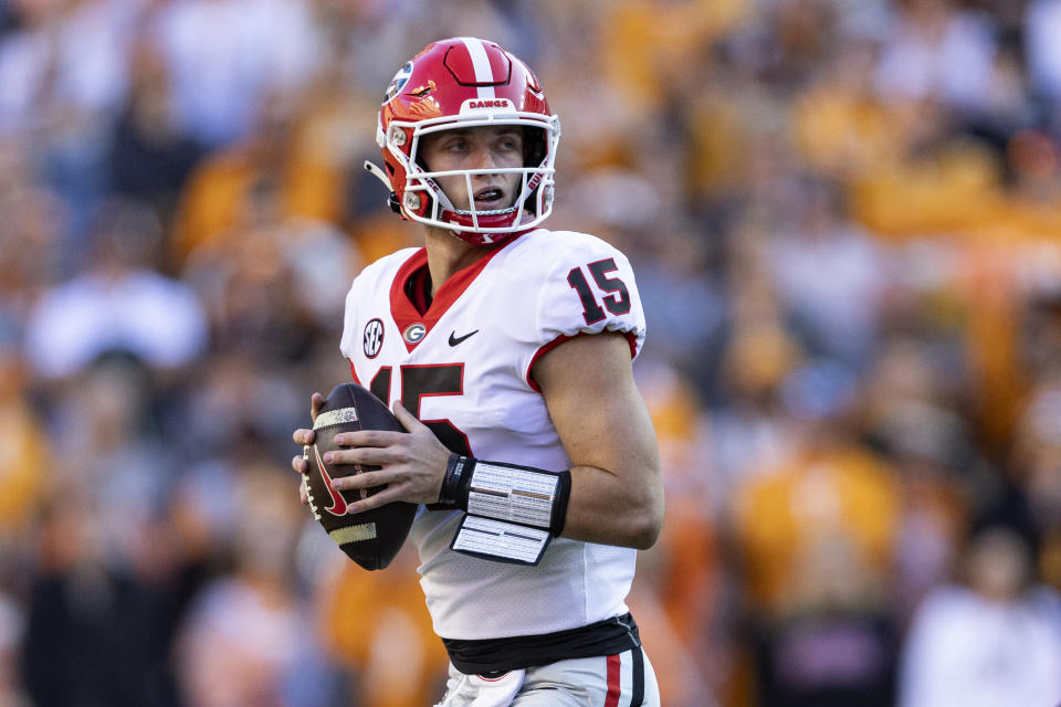 Georgia quarterback Carson Beck (15) looks for a receiver during the first half of an NCAA college football game against Tennessee, Saturday, Nov. 18, 2023, in Knoxville, Tenn. (AP Photo/Wade Payne)