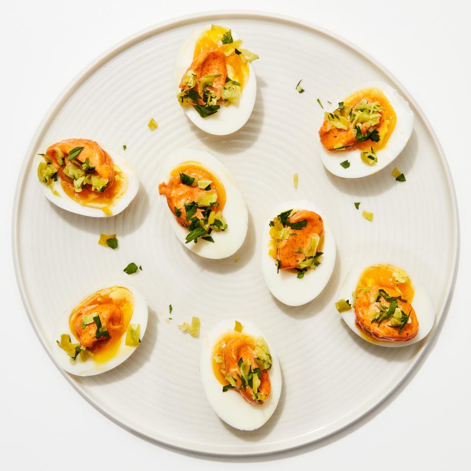 Like deviled eggs—but faster, easier, more delicious, and fancier-sounding. This recipe calls for peperoncini, but most pickle-y things (cornichons, olives, that jar of dilly beans you've had for years) will work just as well. <a rel="nofollow noopener" href="https://www.bonappetit.com/recipe/jammy-eggs-with-paprika-aioli?mbid=synd_yahoo_rss" target="_blank" data-ylk="slk:See recipe.;elm:context_link;itc:0;sec:content-canvas" class="link ">See recipe.</a>