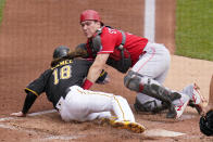 Cincinnati Reds catcher Tyler Stephenson tags out Pittsburgh Pirates' Ben Gamel (18) who was attempting to score from third on a fielder's choice by Michael Perez during the second inning of a baseball game in Pittsburgh, Thursday, Sept. 16, 2021. (AP Photo/Gene J. Puskar)