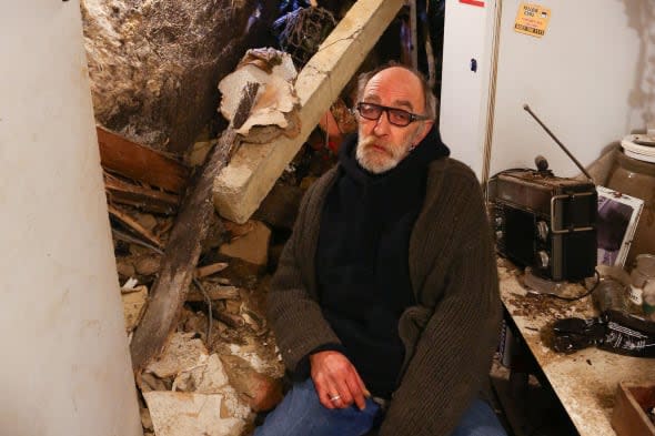 Chris Paraskeva, whose house was badly damaged when a section of the cliff behind buildings in White Rock in Hastings, East Sussex, collapsed, is in dispute with his local council after it asked him to look at arranging to stabilise the crumbling cliffs near his property. PRESS ASSOCIATION Photo. Picture date: Wednesday February 19, 2014. Hastings Borough Council has written Paraskeva expressing concern about potentially more rockfalls at the back of his two-bed, Grade-II listed property which was badly damaged by the collapse. In the letter, the council denied it was responsible for the cliff and asked him to urgently instruct engineers to assess its stability and, if necessary, commission remedial works. See PA story WEATHER Cliff. Photo credit should read: Gareth Fuller/PA Wire