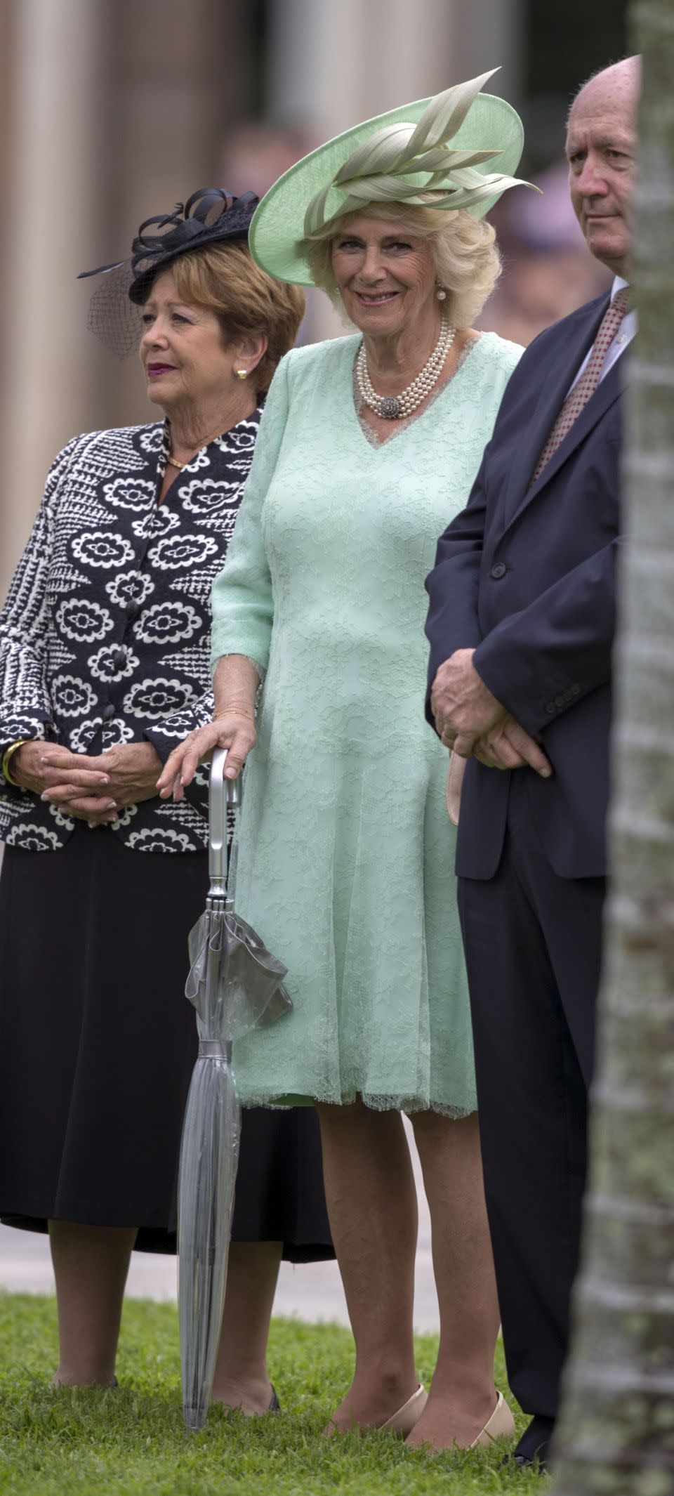 Camilla smiled as she grasped on to an umbrella outside Old Government House in Queensland. Photo: Getty Images