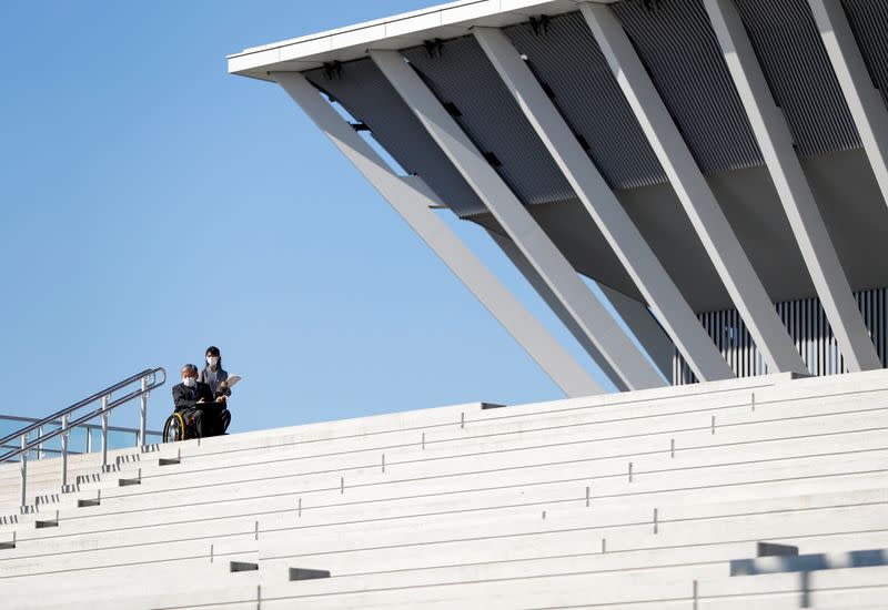 A man riding a wheelchair inspects at the Tokyo Aquatics Centre as the outbreak of the coronavirus disease (COVID-19) continues, in Tokyo