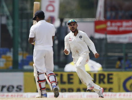 India's captain Virat Kohli (R) celebrates after taking the wicket of Sri Lanka's Kusal Perera during the final day of their third and final test cricket match in Colombo, September 1, 2015. REUTERS/Dinuka Liyanawatte