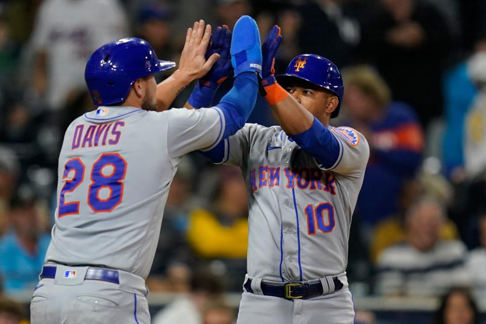 New York Mets' Eduardo Escobar, right, reacts with teammate J.D. Davis (28) after hitting a two-run home run during the eighth inning of a baseball game against the San Diego Padres, Monday, June 6, 2022, in San Diego.