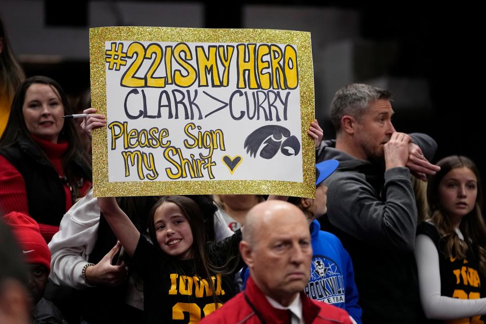 Derica McClure of Liberty Center holds up a sign for Iowa guard Caitlin Clark prior to the Hawkeyes' game at Ohio State on Sunday.