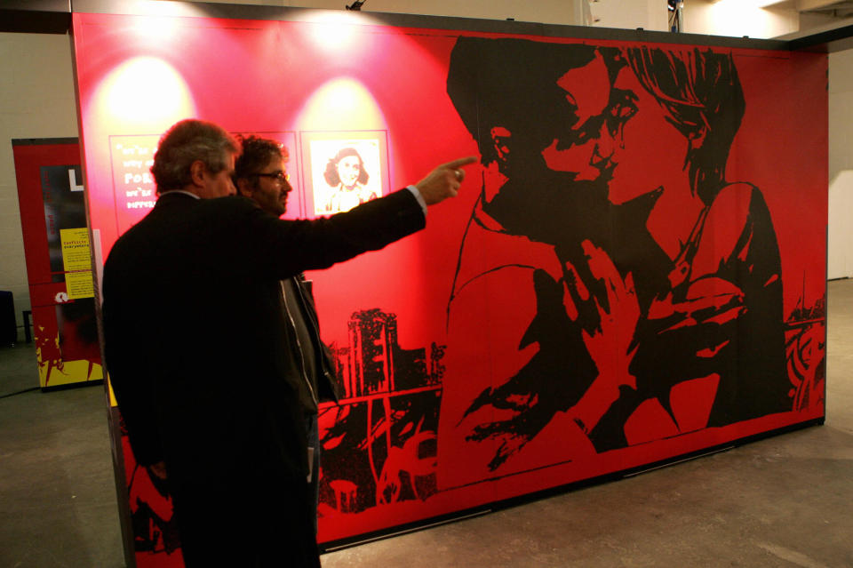 London, UNITED KINGDOM:  Jewish comedian David Baddiel (R) is shown around the new Anne Frank exhibition in Brick Lane, London, 15 June 2005. The exhibition calls on young people to build a society based on mutual respect and moral courage. Born into a German Jewish family in Frankfurt in 1929, Anne Frank moved with her parents to the Netherlands in 1933 when Hitler came to power. After German forces invaded and anti-Jewish legislation came into effect, she and seven other people hid in an Amsterdam attic for two years until they were denounced and deported to Nazi death camps. Only her father survived. The diary was written between June 1942 and August 1944.   AFP PHOTO/JOHN D MCHUGH  (Photo credit should read JOHN D MCHUGH/AFP via Getty Images)