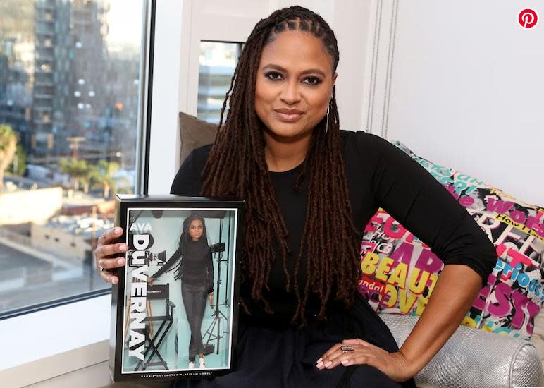 Ava DuVernay, who used Barbie dolls to imagine her own stories, poses with a Barbie of her own. 