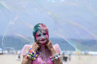 Stephanie Berry, a makeup artist, poses for a photo as bubbles fly over in the heat at Santa Monica Beach on Wednesday, June 16, 2021, in Santa Monica, Calif. (AP Photo/Ringo H.W. Chiu)