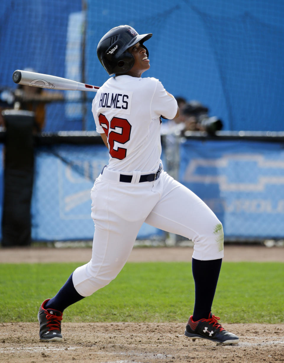 Tamara Holmes, of the United States, watches her hit during a women's baseball game against Venezuela at the Pan Am Games Monday, July 20, 2015, in Ajax, Ontario. Women's baseball made history on Monday at the Pan Am Games, the first time it has been played in a large, multi-sport event.(AP Photo/Mark Humphrey)