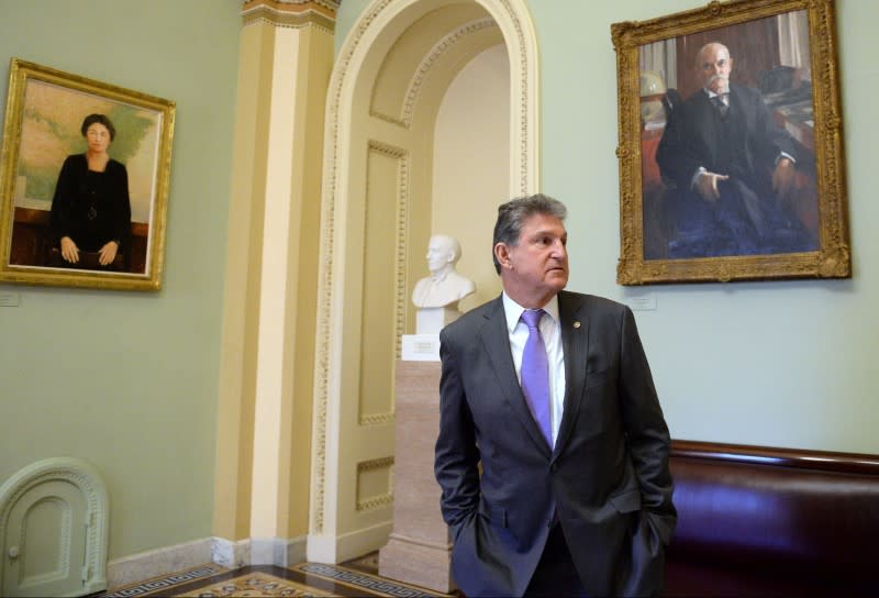 Sen. Joseph Manchin, D-WV pauses outside the Senate Floor during a brief recess of the Senate impeachment trial of President Trump in Washington