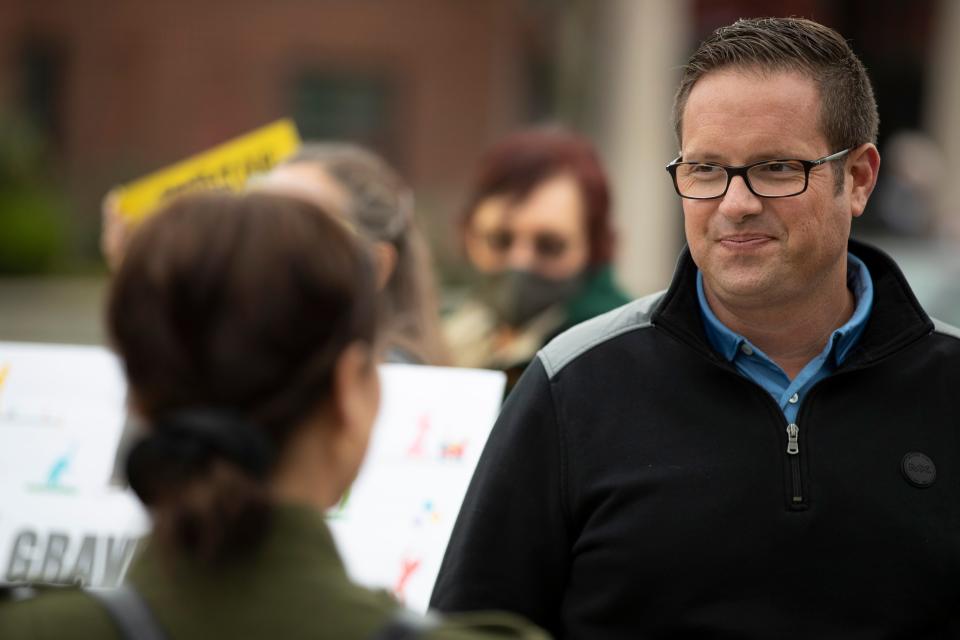 Noblesville mayor Chris Jensen speaks to residents protesting the plans to build a gravel pit next to Potter's Bridge Park outside Noblesville City Hall in Noblesville, Ind. on Monday, October 19, 2020.