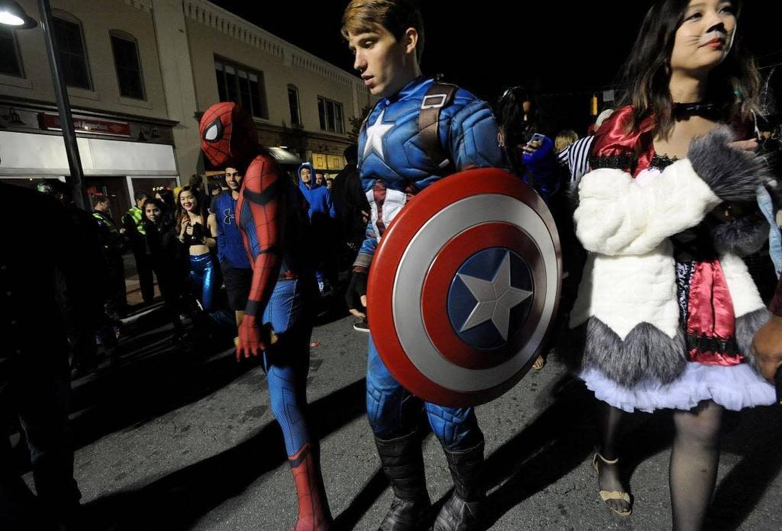 Spiderman, Captain America and thousands of people dressed in costumes parade down Franklin Street Tuesday night during the annual Homegrown Halloween celebration.