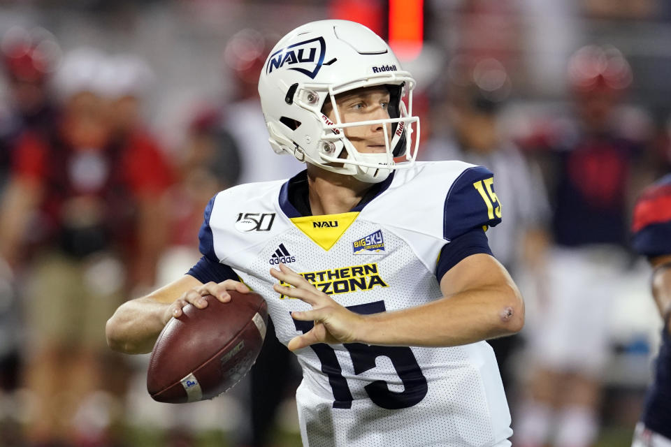 FILE - In this Sept. 7, 2019, file photo, Northern Arizona quarterback Case Cookus looks down field against Arizona in the first half of an NCAA college football game, in Tucson, Ariz. Cookus was selected to The Associated Press FCS All-America first team, Tuesday, Dec. 17, 2019. (AP Photo/Rick Scuteri, File)