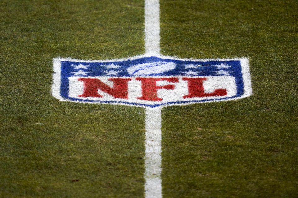 FILE - This Jan. 3, 2021, file photo, shows the NFL logo on the field before an NFL football game between the Denver Broncos and the Las Vegas Raiders in Denver. The NFL has informed teams they could potentially forfeit a game due to a COVID-19 outbreak among non-vaccinated players and players on both teams wouldn’t get paid that week. Commissioner Roger Goodell said Thursday, July 22, 2021, in a memo sent to clubs that was obtained by The Associated Press that the league doesn’t anticipate adding a 19th week to accommodate games that can’t be rescheduled within the 18-week regular season. (AP Photo/Jack Dempsey, File)