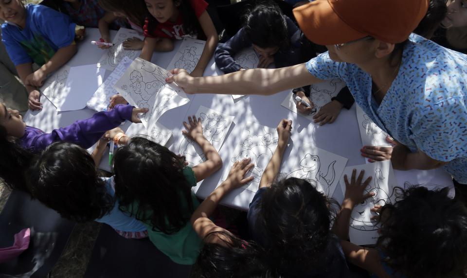 Detainees color and draw at a U.S. Customs and Border Protection processing facility, in Brownsville, Texas June 18, 2014. CPB provided media tours June 18 of two locations in Brownsville and Nogales, Arizona that have been central to processing the more than 47,000 unaccompanied children who have entered the country illegally since Oct. 1. (REUTERS/Eric Gay/Pool)