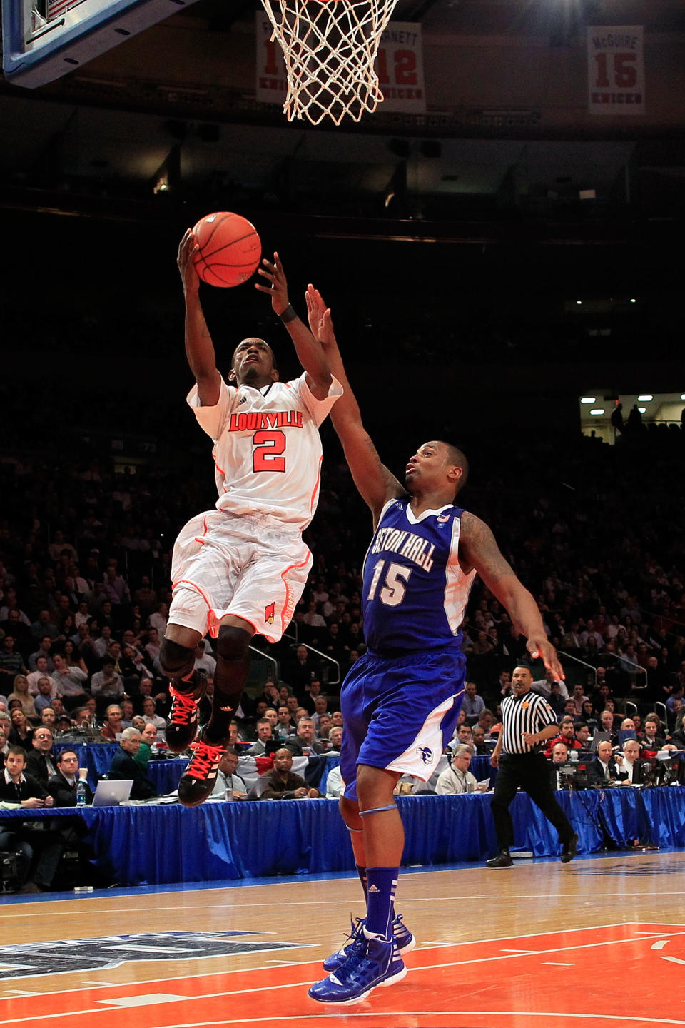 NEW YORK, NY - MARCH 07: Russ Smith #2 of the Louisville Cardinals goes to the basket against Herb Pope #15 of the Seton Hall Pirates during their second round game of the Big East Men's Basketball Tournament at Madison Square Garden on March 7, 2012 in New York City. (Photo by Chris Trotman/Getty Images)