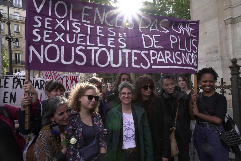 Former Green Party candidate for presidency Sandrine Rousseau, center, attends a demonstration organized by a feminist association called the Observatory on Sexual and Gender-based violence in politics, Tuesday, May 24, 2022 in Paris. Rape accusations against a newly named French government minister have galvanized a movement aimed at exposing sexual misconduct in French politics and encouraging women to speak out against abusers. (AP Photo/Nicolas Garriga)
