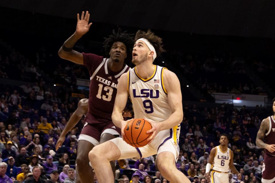 Jan 20, 2024; Baton Rouge, Louisiana, USA; LSU Tigers forward Will Baker (9) dribbles against Texas A&M Aggies forward Solomon Washington (13) during the first half at Pete Maravich Assembly Center. Mandatory Credit: Stephen Lew-USA TODAY Sports